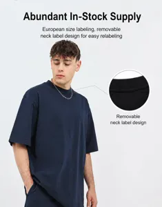 Detail view of the round neckline on a navy oversized heavy cotton washed T-shirt.