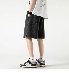 Detailed side view of vintage black acid-wash heavy cotton streetwear shorts for men