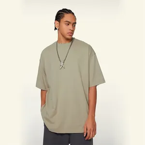 Male model wearing a 230g heavy cotton oversized drop shoulder T-shirt in olive green