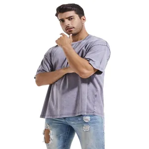 Full shot of a male model wearing a loose fit washed purple heavyweight cotton t-shirt.