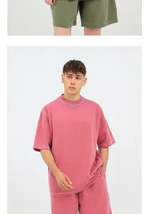 Detailed view of male model in a pink 260g washed distressed oversized cotton t-shirt
