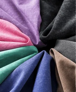 Close-up of heavy cotton fabric samples with washed distressed texture in multiple colors.