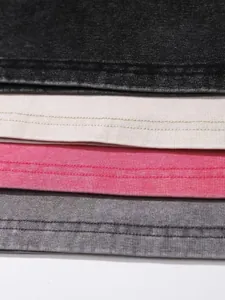 Close-up macro detail showing vintage washed fabric and double-stitched hems of tank tops
