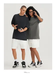 Professional studio shot of models wearing oversized vintage washed t-shirts in grey and black