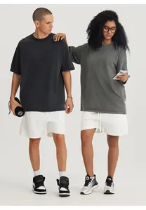 Couple wearing vintage washed oversized t-shirts in charcoal grey with white shorts