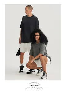 Professional macro view of heavy vintage washed cotton oversized T-shirts worn by models