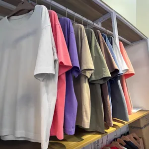 Oversized washed heavy cotton t-shirts in various vintage colors hanging on rack