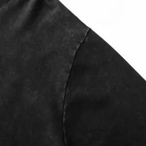 Detailed macro shot of premium acid-washed black hoodie fabric and shoulder seam