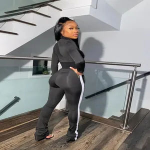 Close-up back view of a black two-piece sports set with white side stripe and snug fit