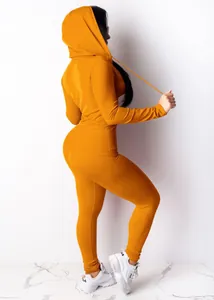 Side view of mustard yellow two-piece tracksuit set with hooded top and leggings
