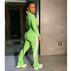 Detail of bright green two-piece athletic set with side stripes and mock neck top