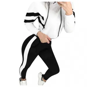 Stylish white and black two-piece tracksuit featuring a hooded crop top and striped leggings
