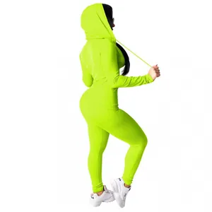 Side view of a vibrant neon green hooded sports two-piece set featuring a slim fit silhouette