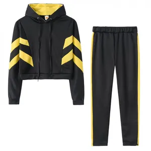 Women's black two-piece tracksuit set with yellow stripes and cropped hoodie detail view