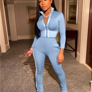 Light blue women's two-piece sports tracksuit with zip-up cropped top and leggings set
