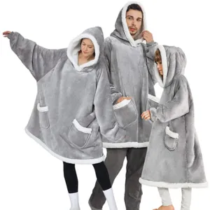 Family in matching oversized grey sherpa-lined wearable blanket hoodies for warmth