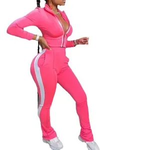 Vibrant two-piece pink women's tracksuit with white side stripes and flare pants