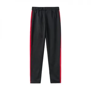 Detailed back view of black athletic jogger pants featuring vibrant red side stripes