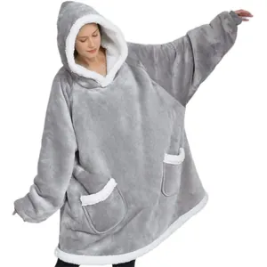 Detail showing the thick sherpa lining and soft grey fleece of the oversized wearable blanket.