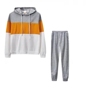 Tuta sportiva da donna in due pezzi con felpa color block e pantaloni grigi coordinati