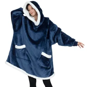 Close-up of oversized navy blue fleece wearable blanket with white sherpa lining and pockets