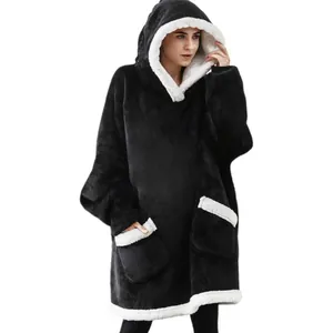 Detailed view of an oversized black wearable blanket hoodie with white fleece lining trim