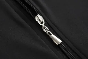 Close-up detail of high-quality silver metallic zipper on black sports tracksuit.