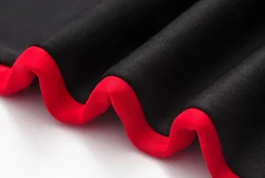 Close-up detail of black and red ribbed hem on women's hooded crop top hoodie set.