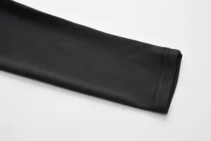 Close-up detail of the black elastic sleeve cuff stitching on a sports garment set