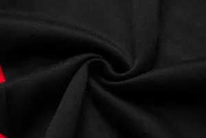 Close-up of black knit fabric texture for women's cropped hoodie tracksuit