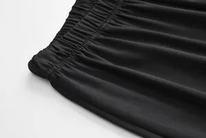 Detailed macro view of the elastic gathered waistband on black sports leisure pants