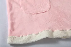 Macro view of pink soft fleece texture and white lamb wool hem on hoodie pajama