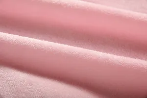 Macro detail of soft pink lamb wool fleece fabric for cozy wearable blanket hoodie