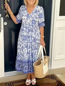Detail view of a blue and white floral tie-dye maxi dress worn in a lifestyle setting