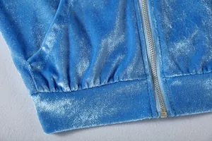 Detail close-up of blue gold velvet casual hoodie featuring metal zipper and soft texture