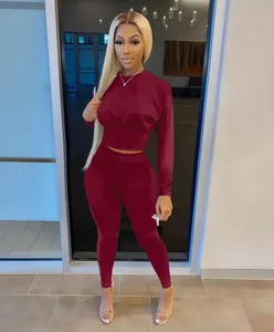 Stylish burgundy two-piece outfit featuring long-sleeve cinched waist top and leggings