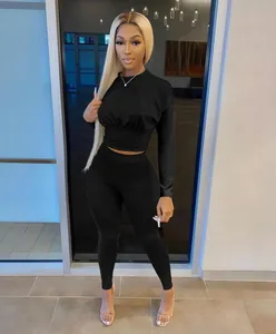 Women's chic black long-sleeve cinched waist top and leggings two-piece set detail view