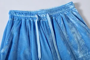 Close-up of elastic waistband on light blue velvet wide-leg loungewear pants