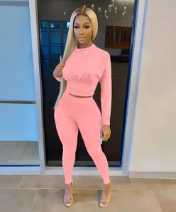 Pink two-piece loungewear set with long sleeve crop top and high waist leggings