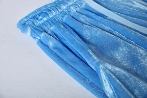 Detailed close-up showing light blue velour fabric and elastic waistband on wide-leg pants