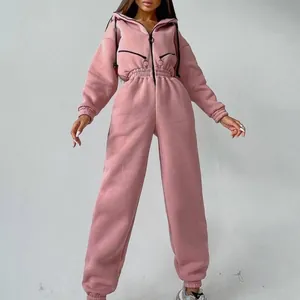 Close-up of pink women's hooded jumpsuit with elastic waist and front zipper detail