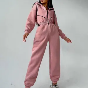 Stylish pink hooded long-sleeve athletic jumpsuit with elastic waist and drawstring for women.