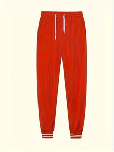 Vista dettagliata di pantaloni sportivi arancioni marmorizzati con coulisse e polsini