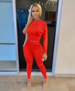 Vibrant red two-piece women's athletic set featuring cinched waist top and matching leggings