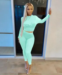 Fashionable mint green two-piece lounge set with waist-cinched long sleeve top and leggings