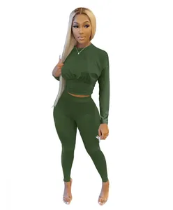 Detail view of olive green long-sleeve crop top and matching leggings sports set