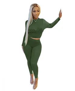 Olive green two-piece sporty set featuring cinched waist crop top and matching leggings