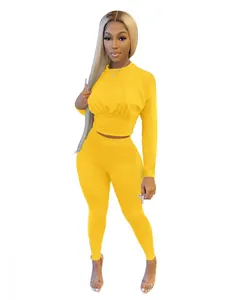Full view of vibrant yellow two-piece set featuring long sleeve top and slim pants
