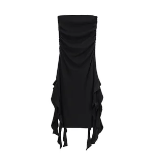 Close-up detail of a black strapless bodycon dress with elegant irregular side ruffles.