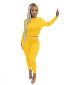 Vibrant yellow solid color sports two-piece set with long sleeves and cinched waist